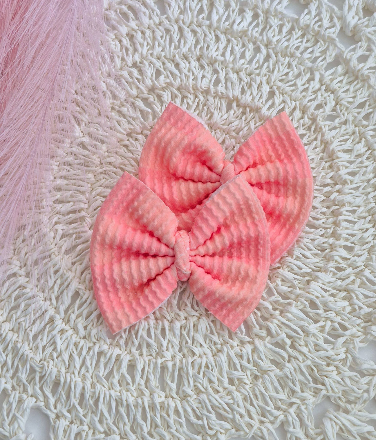 Peach colored piggies set bows on a white lace background.
